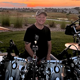 Ernie Navarette sitting behind a drum kit